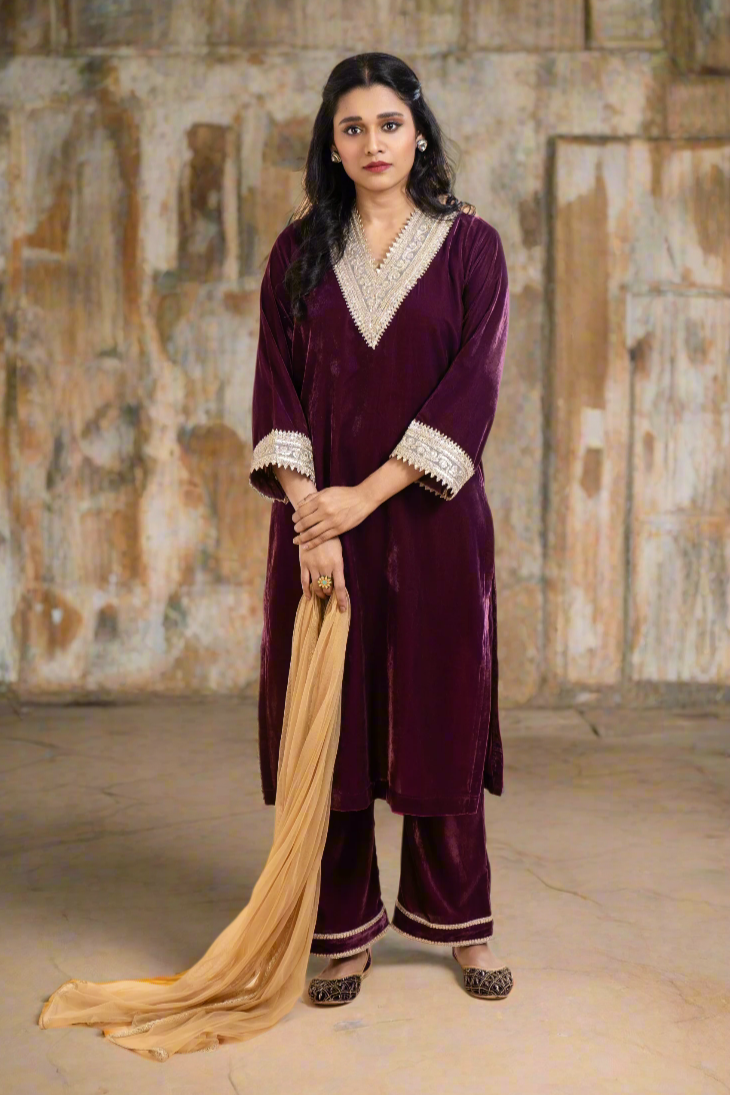 Woman wearing the Amara deep plum velvet kurta set with dupatta for Diwali
