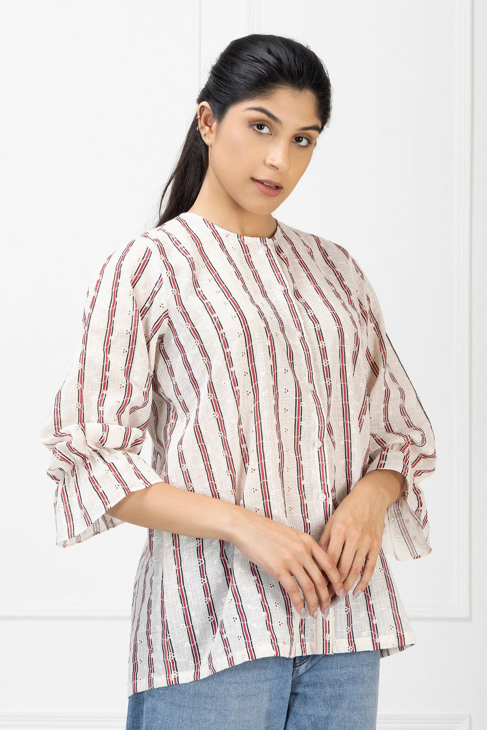 Woman wearing a red and white striped shirt against a white background