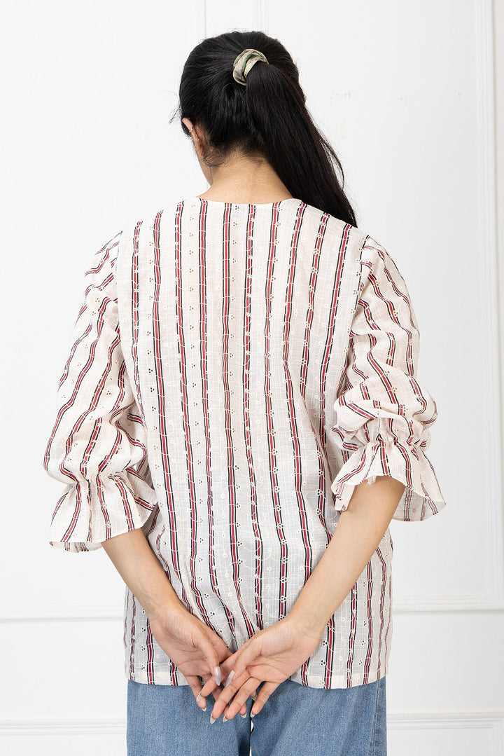 Person wearing a red and white striped shirt with blue pants against a white background