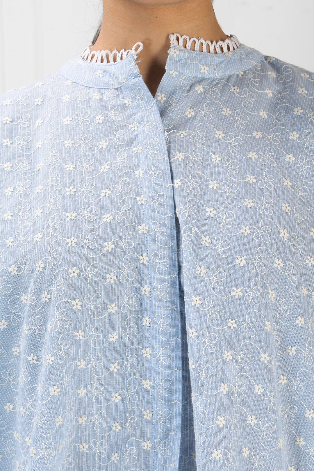 Light blue fabric with white floral patterns on a plain background