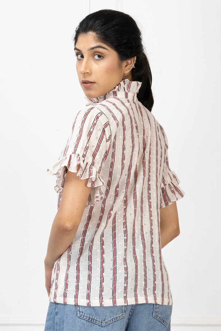 Woman wearing a striped shirt and jeans on a white background