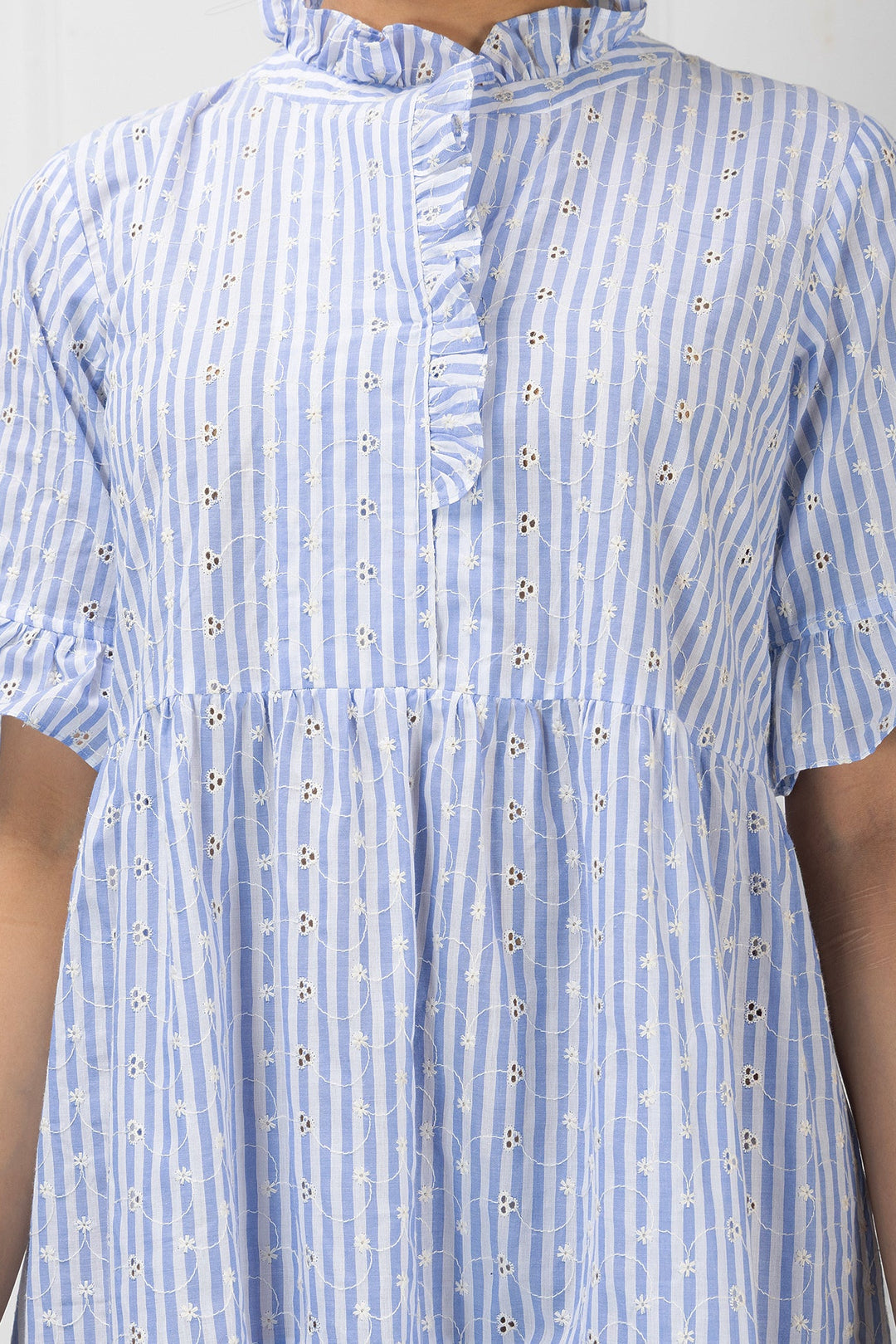 Blue and white striped dress with ruffled collar on a plain background