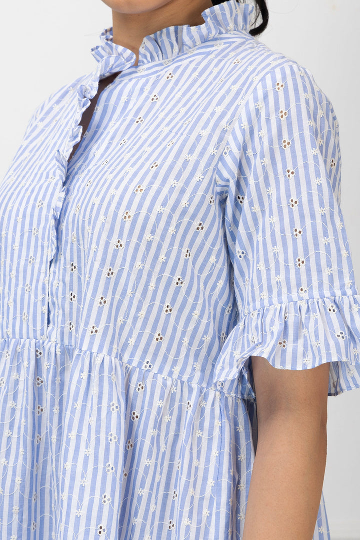 Blue and white striped dress with floral details on a plain background
