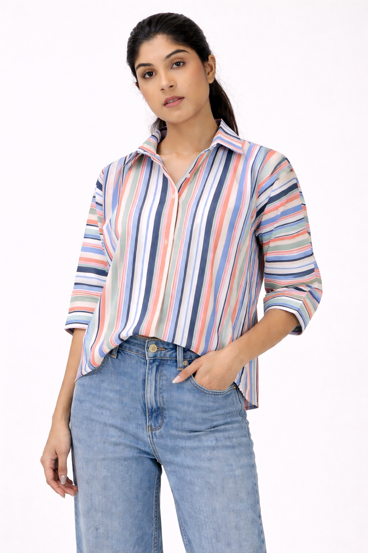 Woman wearing a striped shirt and jeans on a white background
