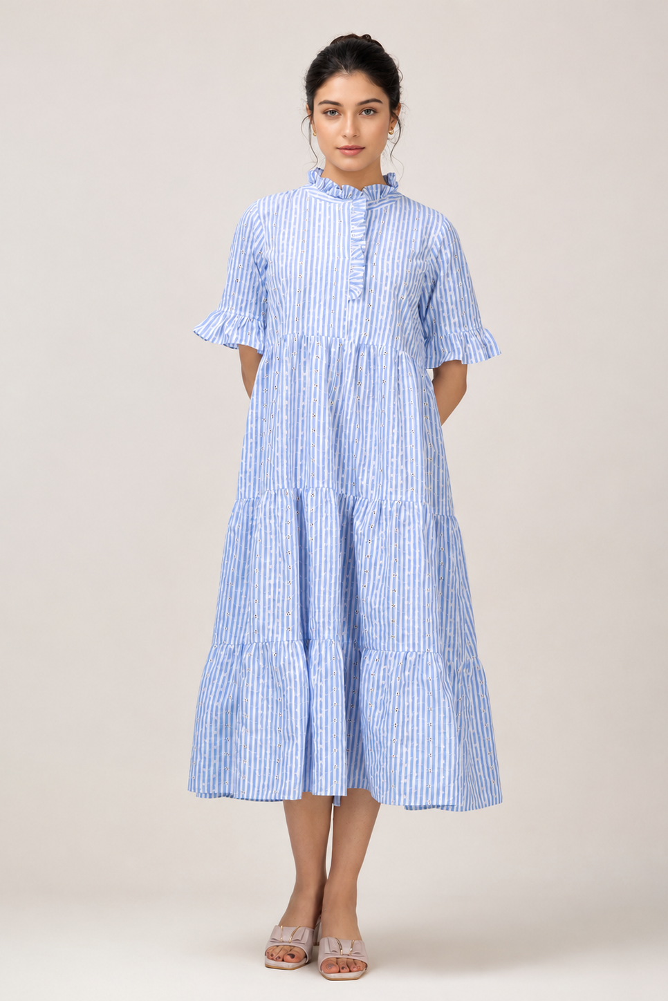 Woman wearing a blue and white striped dress on a beige background