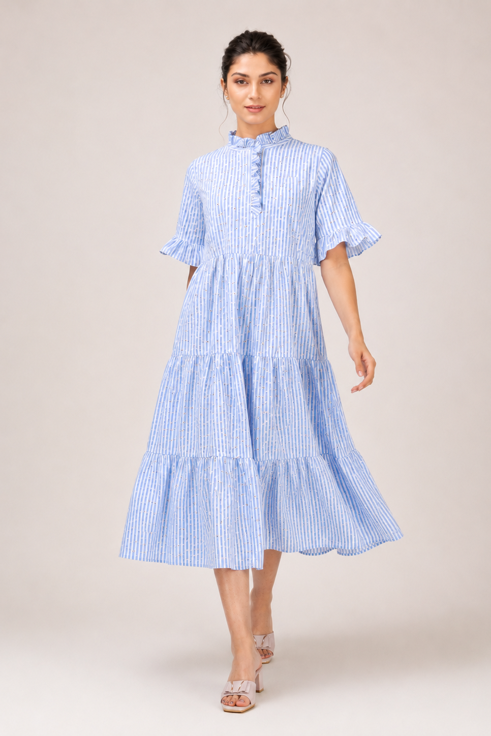 Woman wearing a blue and white striped dress on a beige background