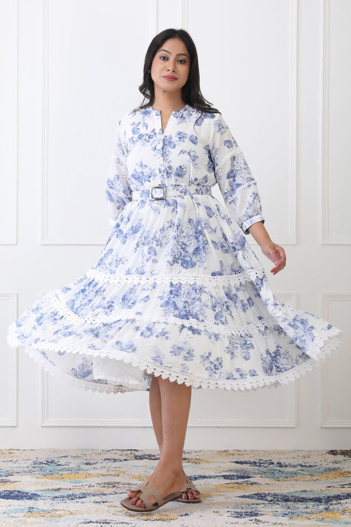Woman wearing a blue floral dress with a white background