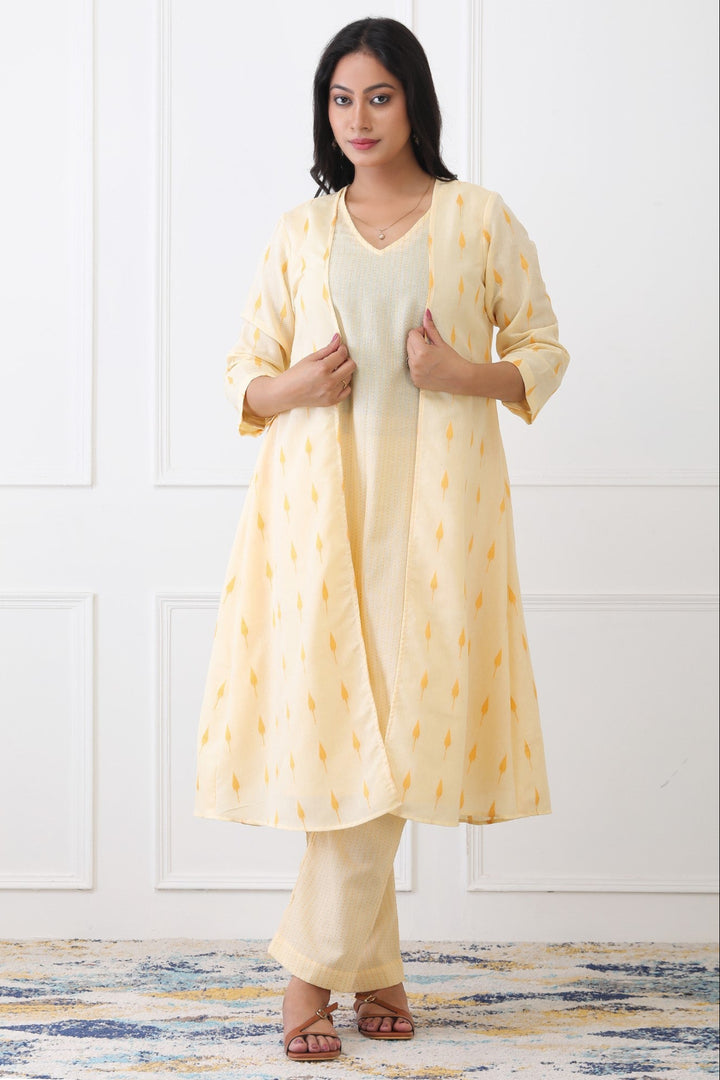 Woman wearing a yellow kurta with a matching dupatta against a white background