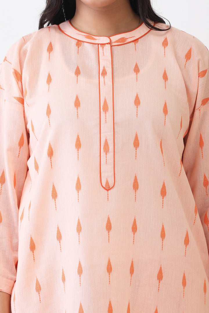 Light pink kurta with orange patterns worn by a person