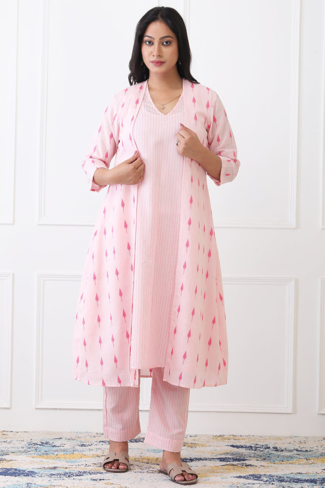 Woman wearing a pink traditional outfit with a white background