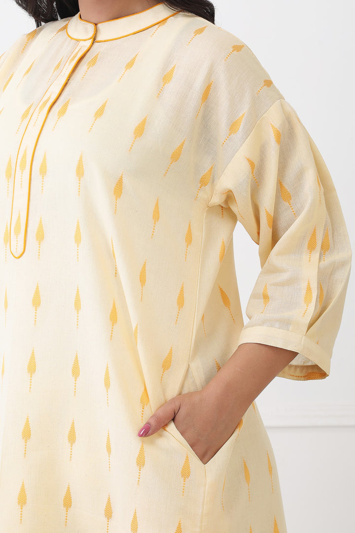 Light yellow kurta with small patterns worn by a person, on a white background