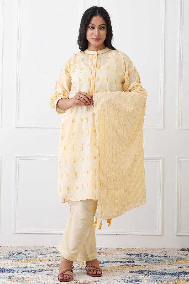 Woman wearing a light yellow traditional outfit with a white background