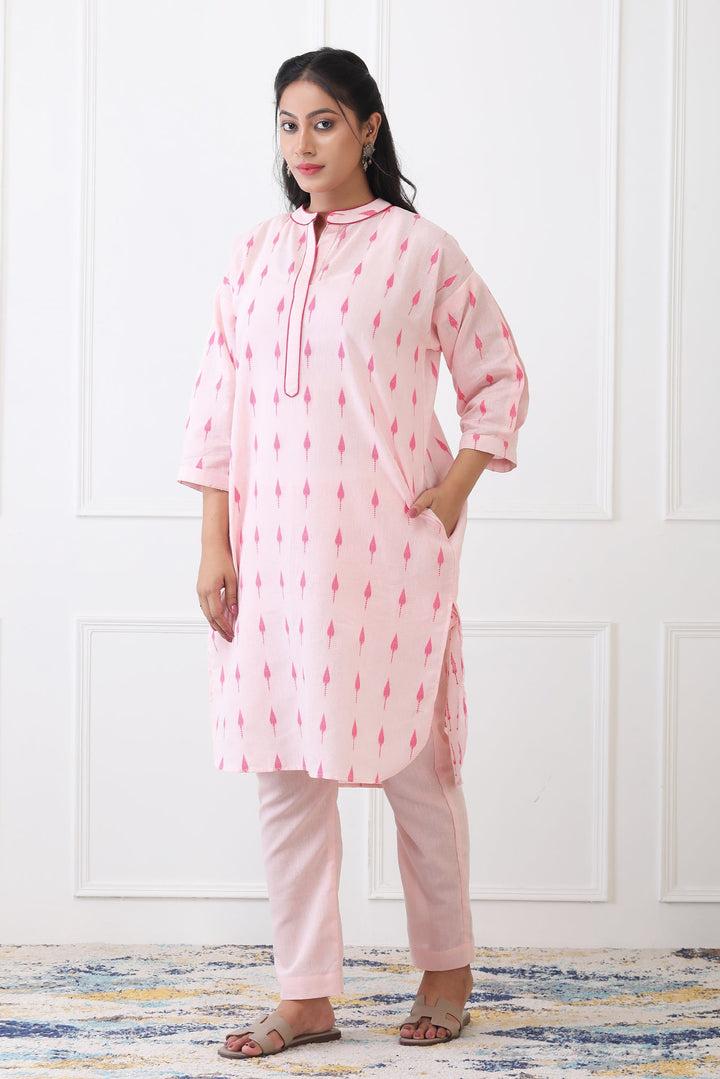 Woman wearing a pink and white traditional outfit with a white background