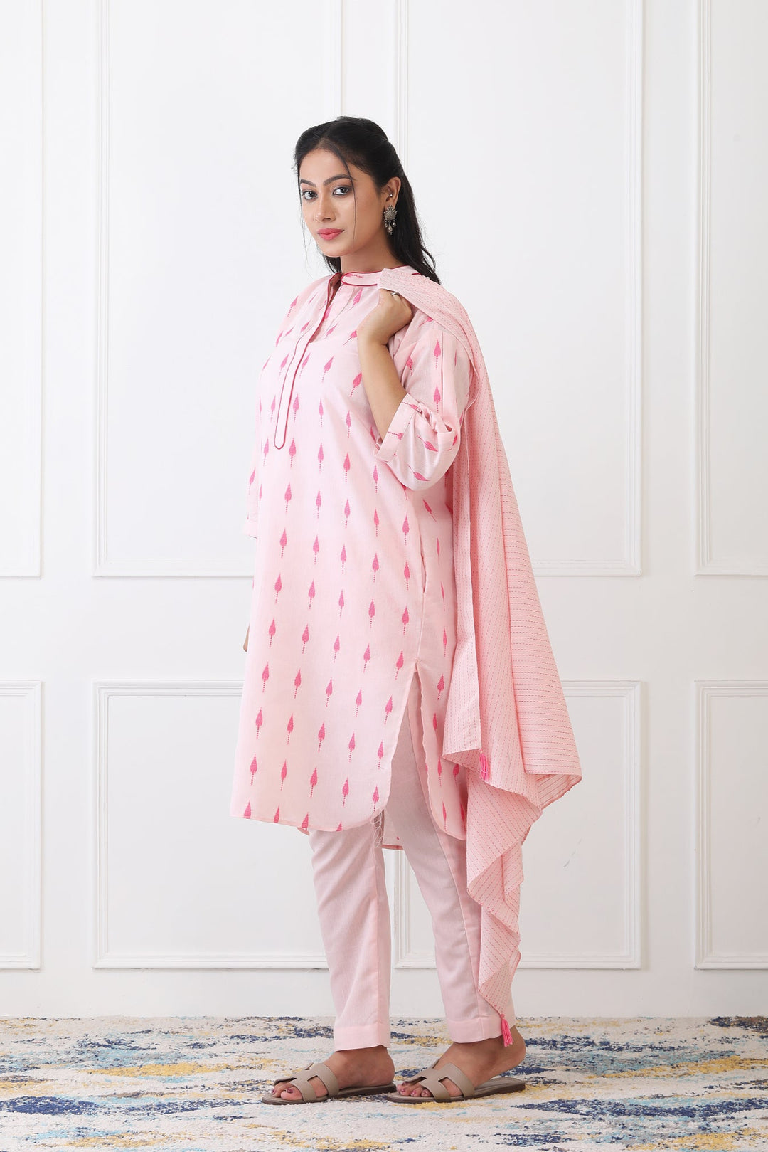 Woman wearing a pink traditional outfit with a white background