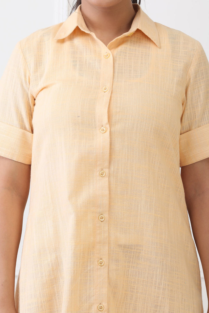 Yellow dress shirt worn by a person on a white background