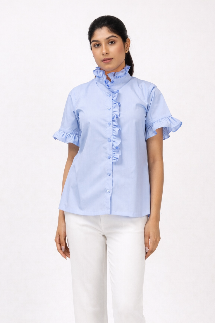 Woman wearing a light blue shirt and white pants on a white background