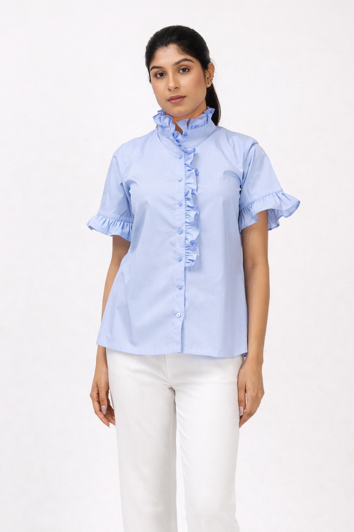Woman wearing a light blue shirt and white pants on a white background