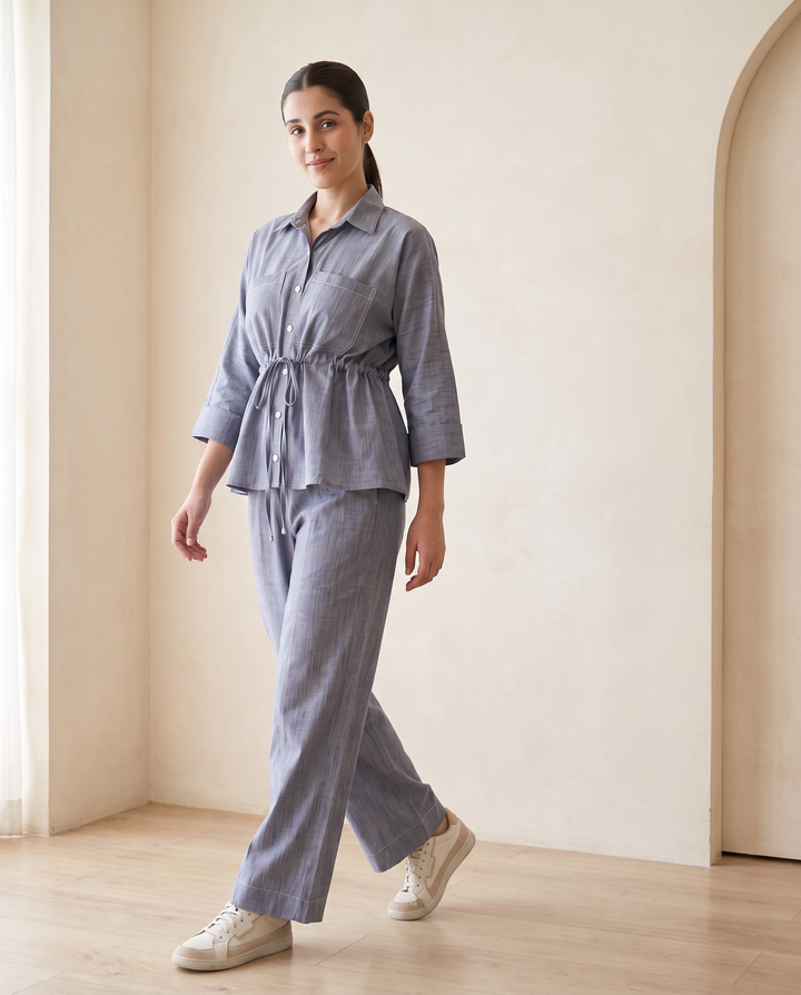 Alexis denim chambray co-ord set in motion, showing the peplum shirt and wide-leg trouser drape