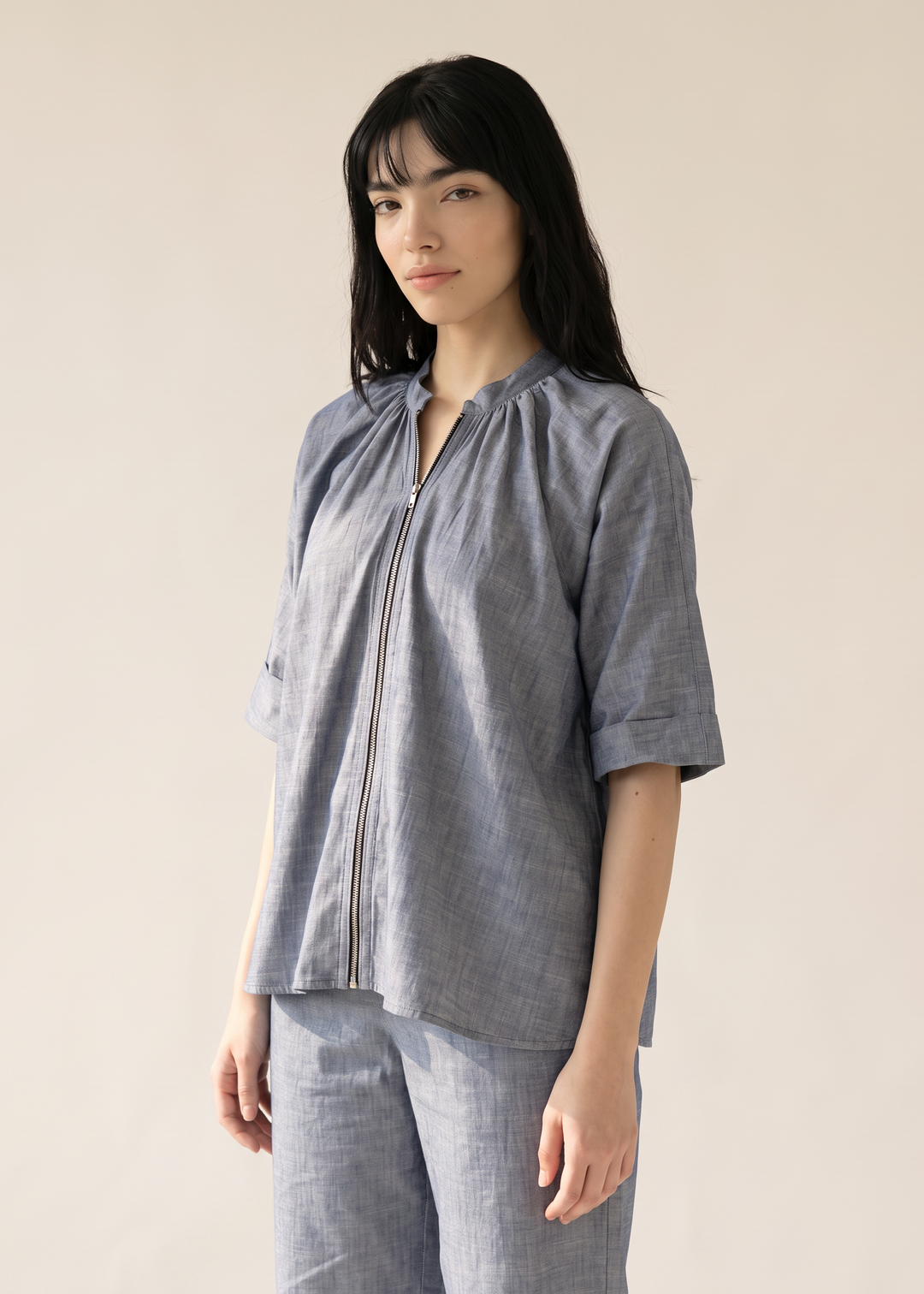 Close-up of the Margot jacket's gathered collar, silver zip and cotton-linen texture